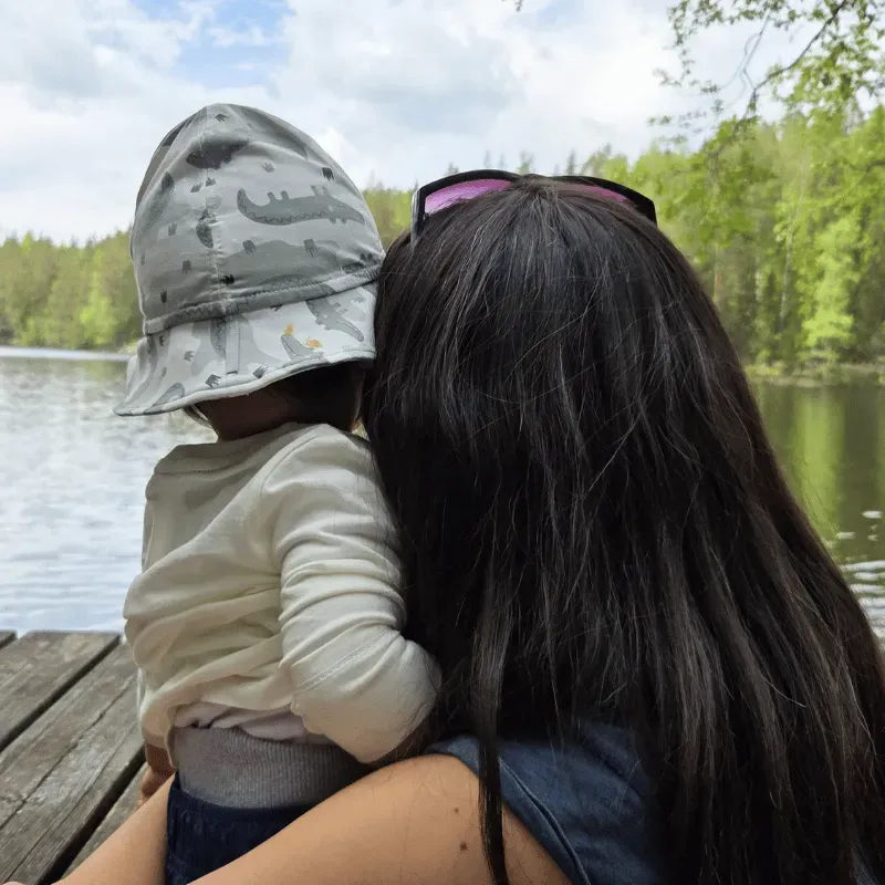 Carmen with baby enjoying nature by a Finnish lake